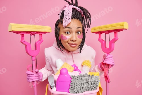 Preview: Housekeeping and cleaning service. Surprised young woman with braided hair applies hydrogel patches