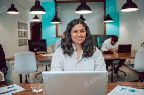 Preview: Cheerful Hispanic woman working on laptop in office