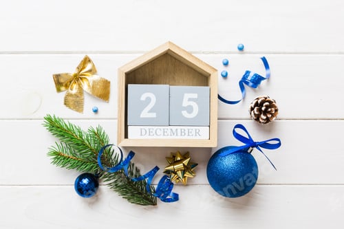 Preview: Christmas calendar 25 december. Christmas gift, fir branches, pine cones. Flat lay, top view.