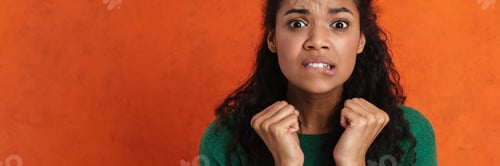 Preview: Worried young african woman in casual wear standing