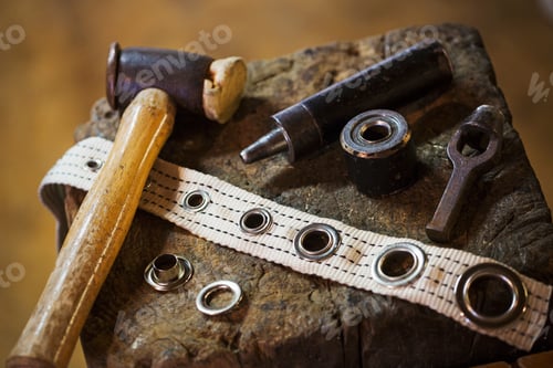 Preview: Close up of tools and eyelets in a sailmaker's workshop.