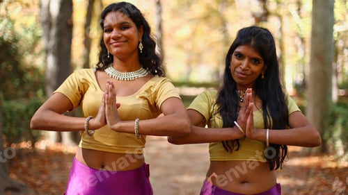 Preview: Indian women greeting with namaste gesture outdoors