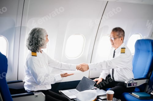 Preview: Mature commercial male pilot Beautiful middle aged woman airplane captain instructor has a meeting,