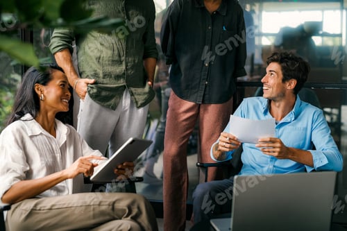 Preview: Multicultural professional businesspeople working together on research plan in boardroom.