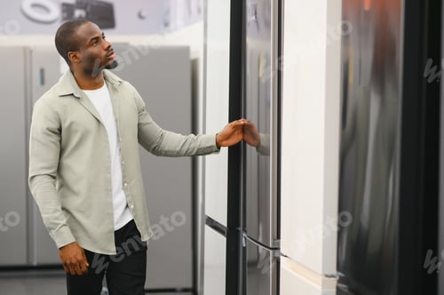 Preview: Customer choosing refrigerator in electronics store appliance shop