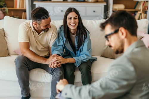 Preview: Happy couple holding hands during counseling session
