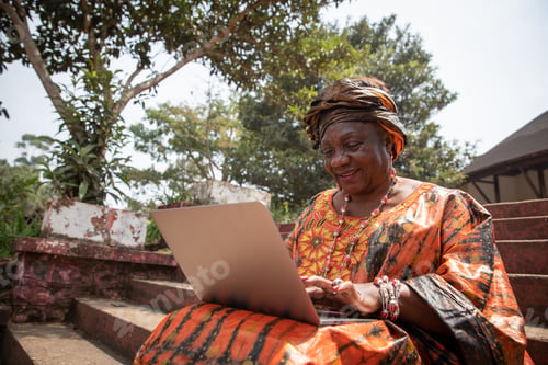 Preview: 60 year old African woman uses her laptop, women and technology concept