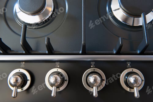 Preview: A kitchen stove with gas burners and control knobs.