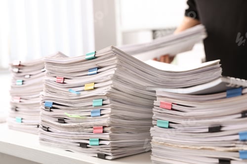 Preview: Stacks of documents with paper clips on office desk