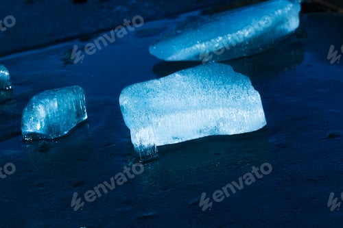 Preview: A piece of blue ice glows in the sun. Abstract blue cold ice. Big piece of ice.
