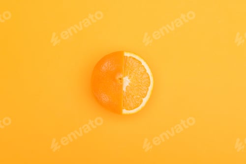 Preview: top view of fresh ripe partially cut orange on orange background