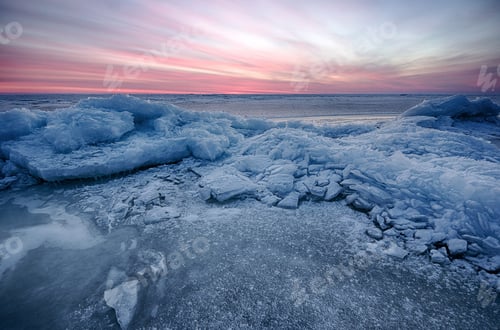 Preview: Abstract frozen winter sunrise seascape with ice and colored the sky.