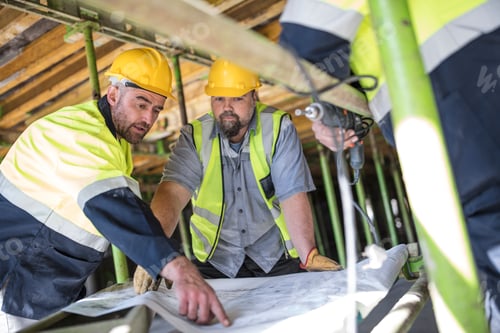 Preview: Construction workers looking at plans