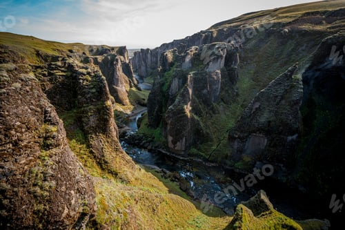 Preview: Canyon Fjaðrárgljúfur. Amazing Iceland's landscape with little river near the rocky waves.