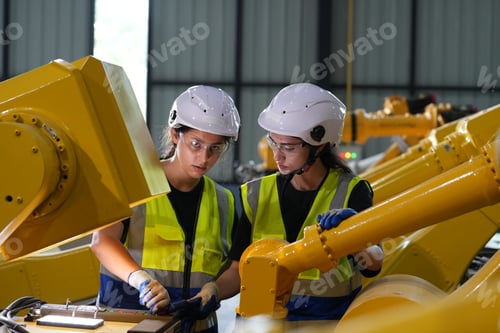 Preview: Robotics engineer working on maintenance of robotic arm in factory warehouse. Business technology.