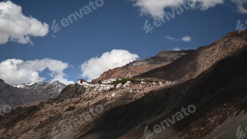 Preview: Scenic view of a mountain side, featuring several houses on the peaks