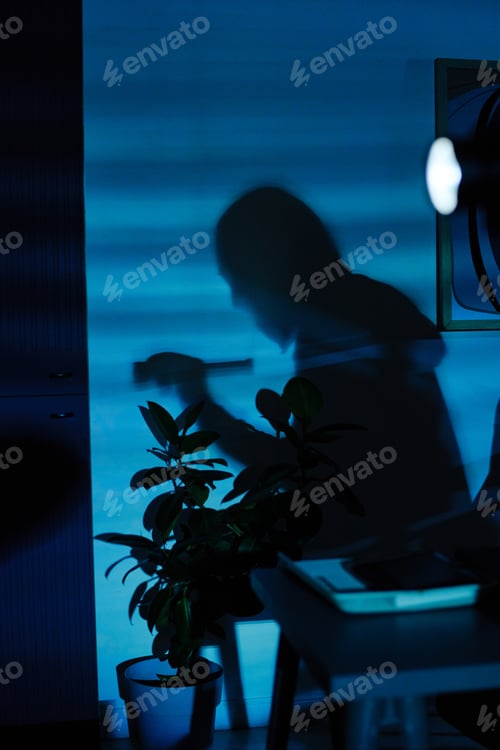 Preview: Silhouette of Young Adult Man Breaking into Office and Stealing Documents