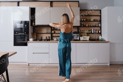 Preview: Woman in pajama dancing at home in the living room