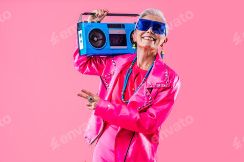 Preview: Happy and funny senior old woman on colorful background