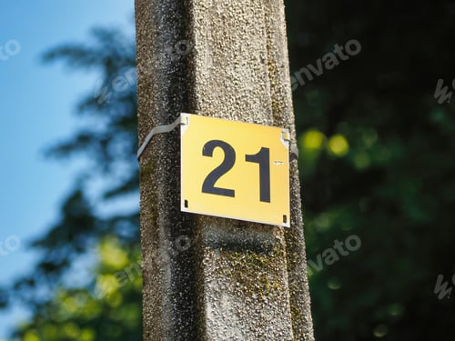 Preview: Selective focus shot of sign with numbers twenty-one on a pole outside