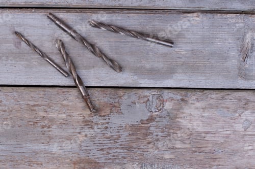 Preview: Rusty drill bits on wooden background