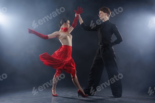 Preview: Dance Couple Performing Expressive Arm Movement in Dramatic Studio Light