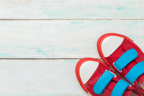 Preview: Red retro sneakers on a blue wooden background