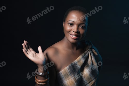 Preview: Smiling Traditional Xhosa Woman Wearing Brown Fabric And Bracelets.