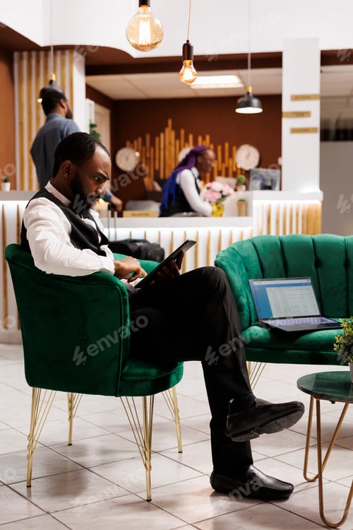 Preview: Hotel bellboy using digital device