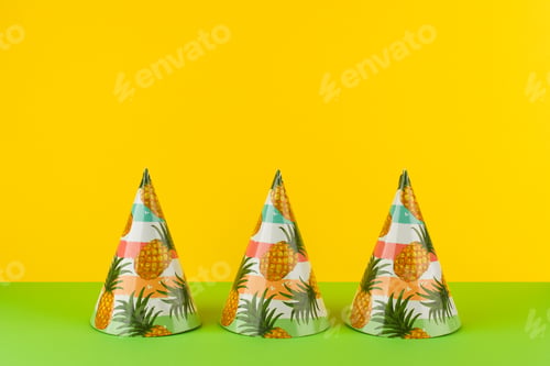 Preview: Birthday Party Hats with pineapples on yellow with green background.