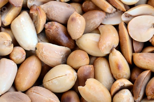 Preview: Peanut. A lot of small yellow nuts without peel. Background texture