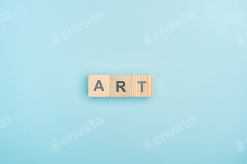 Preview: top view of art lettering made of wooden cubes on blue background