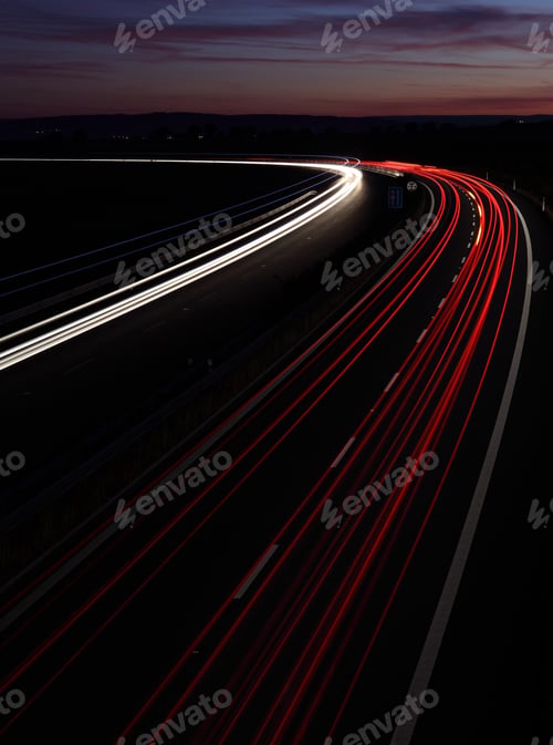 Preview: Cars in a rush moving fast on a highway (speedway) at dusk in the UK