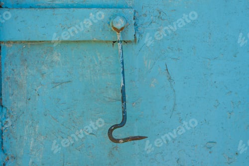 Preview: Texture background blue painted cracked iron surface, metal hook plug on the door