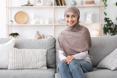 Preview: Modern Modesty. Portrait Of Beautiful Islamic Woman In Hijab In Home Interior