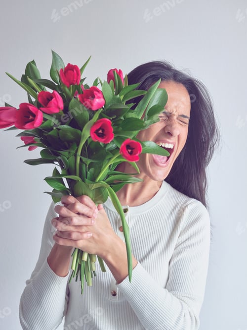 Preview: Woman Excitedly Holding a Bouquet of Red Tulips
