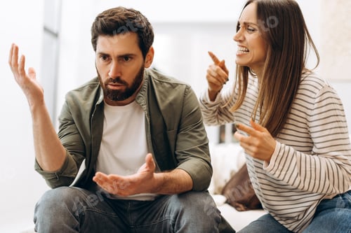 Preview: Young couple arguing vehemently at home on sofa