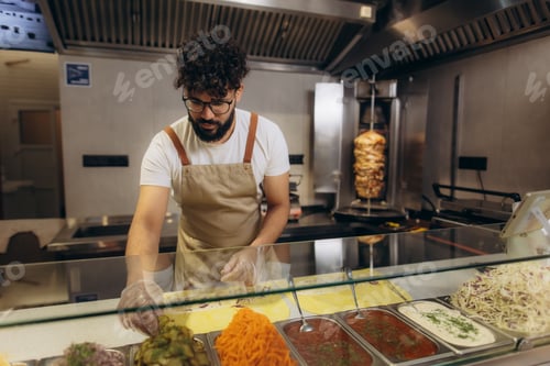 Preview: Chef making shawarma or doner kebab in restaurant