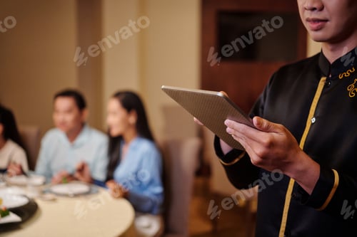 Preview: Waiter Using Tablet PC To Take The Order
