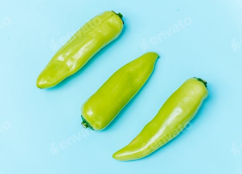 Preview: Aerial view of fresh jalapeno peppers on blue background