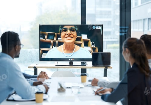 Preview: Shot of a group of businesspeople having a video call with a colleague in an office