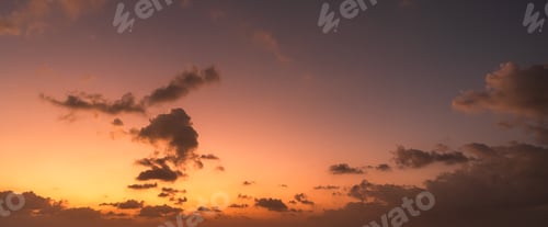 Preview: Sunset sky clouds in the evening wide panorama with orange sunlight