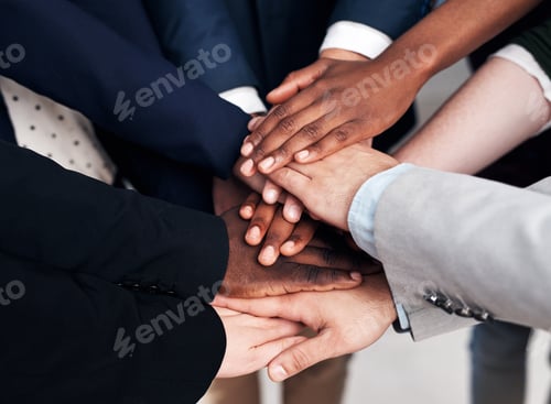 Preview: Cropped shot of a group of businesspeople joining their hands in solidarity