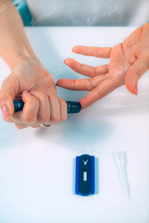 Preview: Woman Using Lancet to Draw Blood for Rapid Corona Virus Home Test