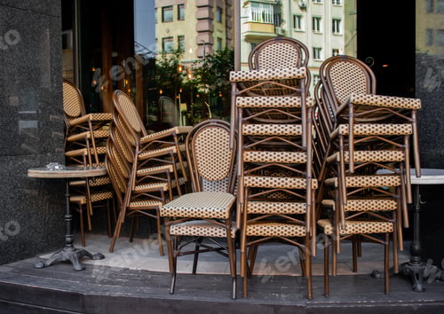 Preview: Piled one on other cafe chairs: pandemic time, closed restaurants, unemployment, empty, cafe closed