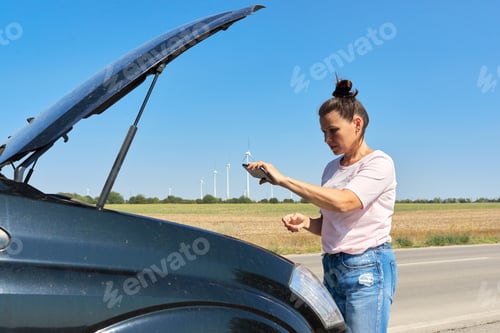Preview: Mature upset woman driver calling on mobile phone for help, female near broken car