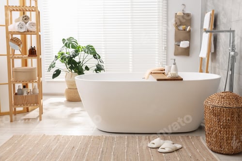 Preview: Set of different bath accessories and soap on tub in bathroom
