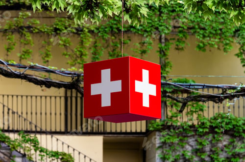 Preview: Swiss cube flag hanging from a tree branch