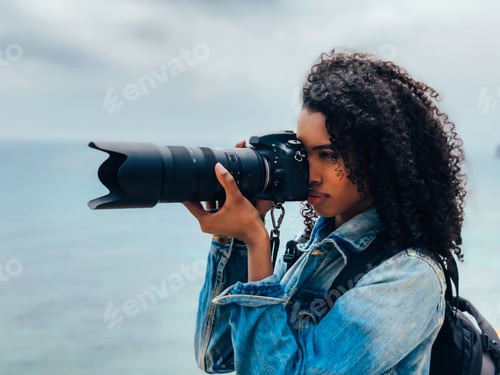 Preview: Photographer taking a picture of a ocean coast