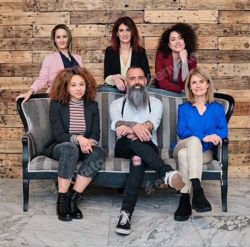 Preview: Diverse group of businesspeople looking at camera while posing together in their office.